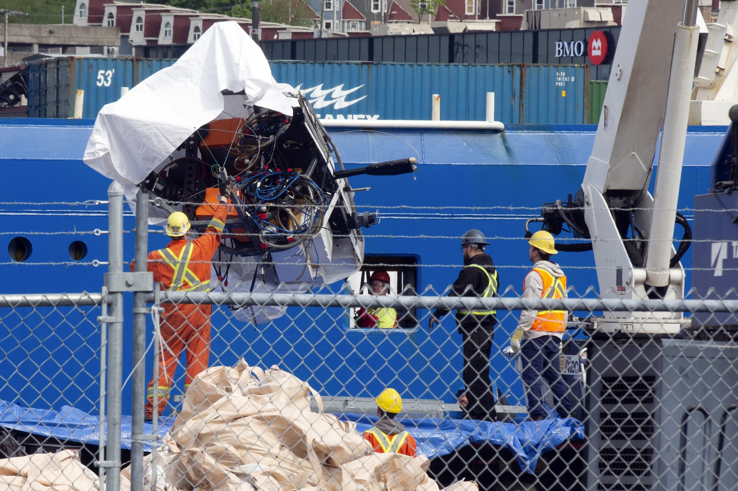 FILE - Debris from the Titan submersible, recovered from the ocean floor near the wreck of the Titanic, is unloaded from the ship Horizon Arctic at the Canadian Coast Guard pier in St. John's, Newfoundland, Wednesday, June 28, 2023. OceanGate, the company that owned a submersible that imploded on its way to explore the wreck of the Titanic, killing all five onboard, said Thursday, July 6, that it has suspended operations. (Paul Daly/The Canadian Press via AP, File) 13510649