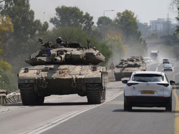 A tank rolls toward the border with Gaza